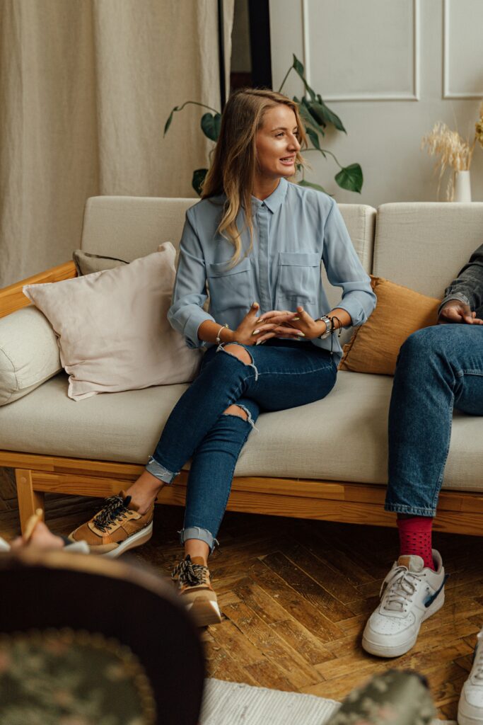 Woman sitting on couch talking 