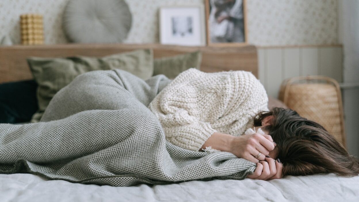 woman in bed experiencing trauma