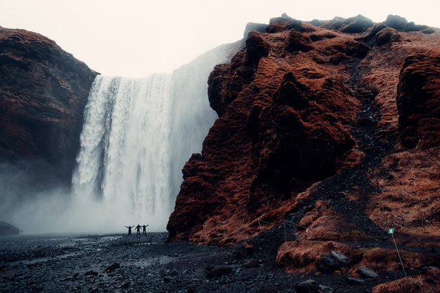 People in front of a waterfall enjoying nature 