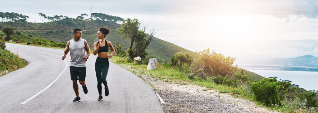 Couple jogging on roadside