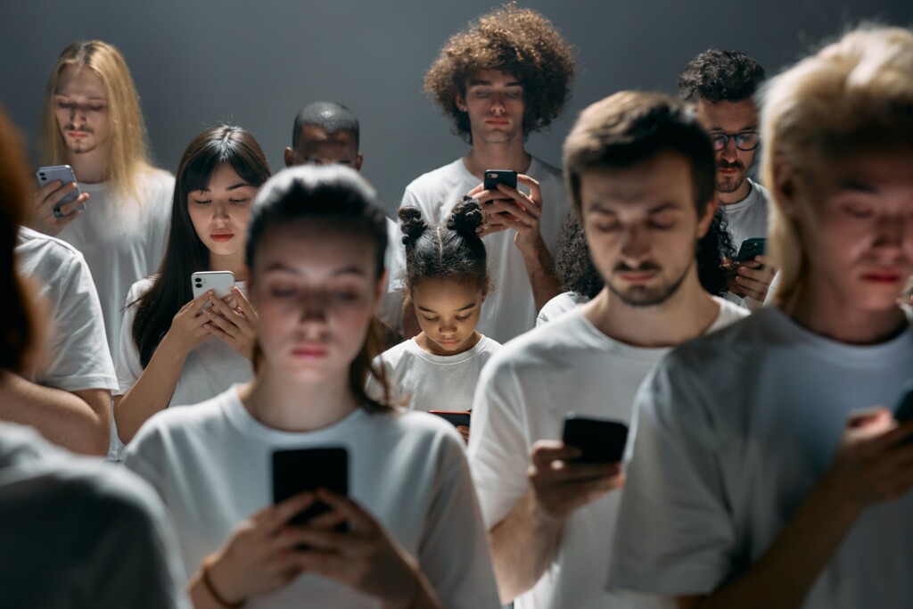 Crowd of people scrolling on social media 