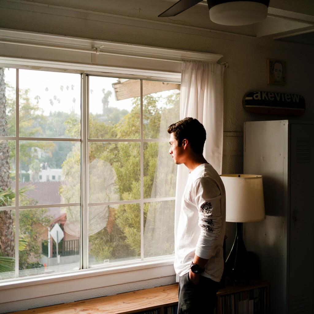 Man taking a break from work looking out the window