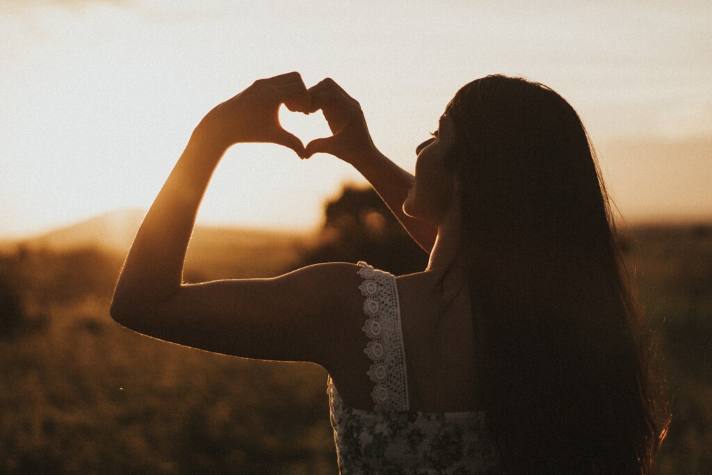 Woman making a heart shape with hands 