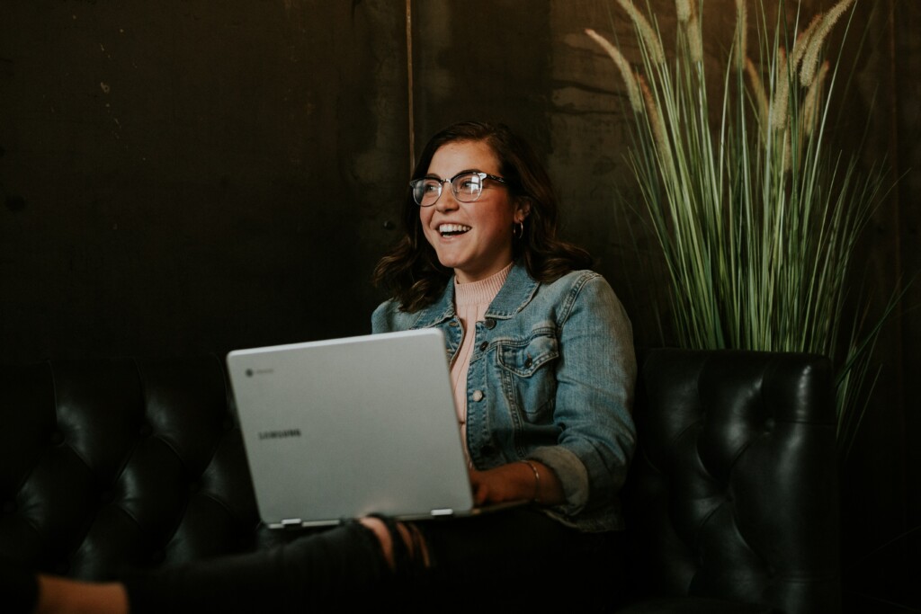 Woman on couch with computer. Online therapy 